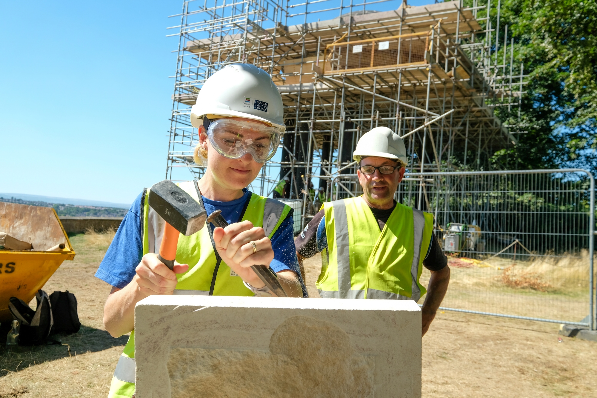An apprentice learning to carve stone